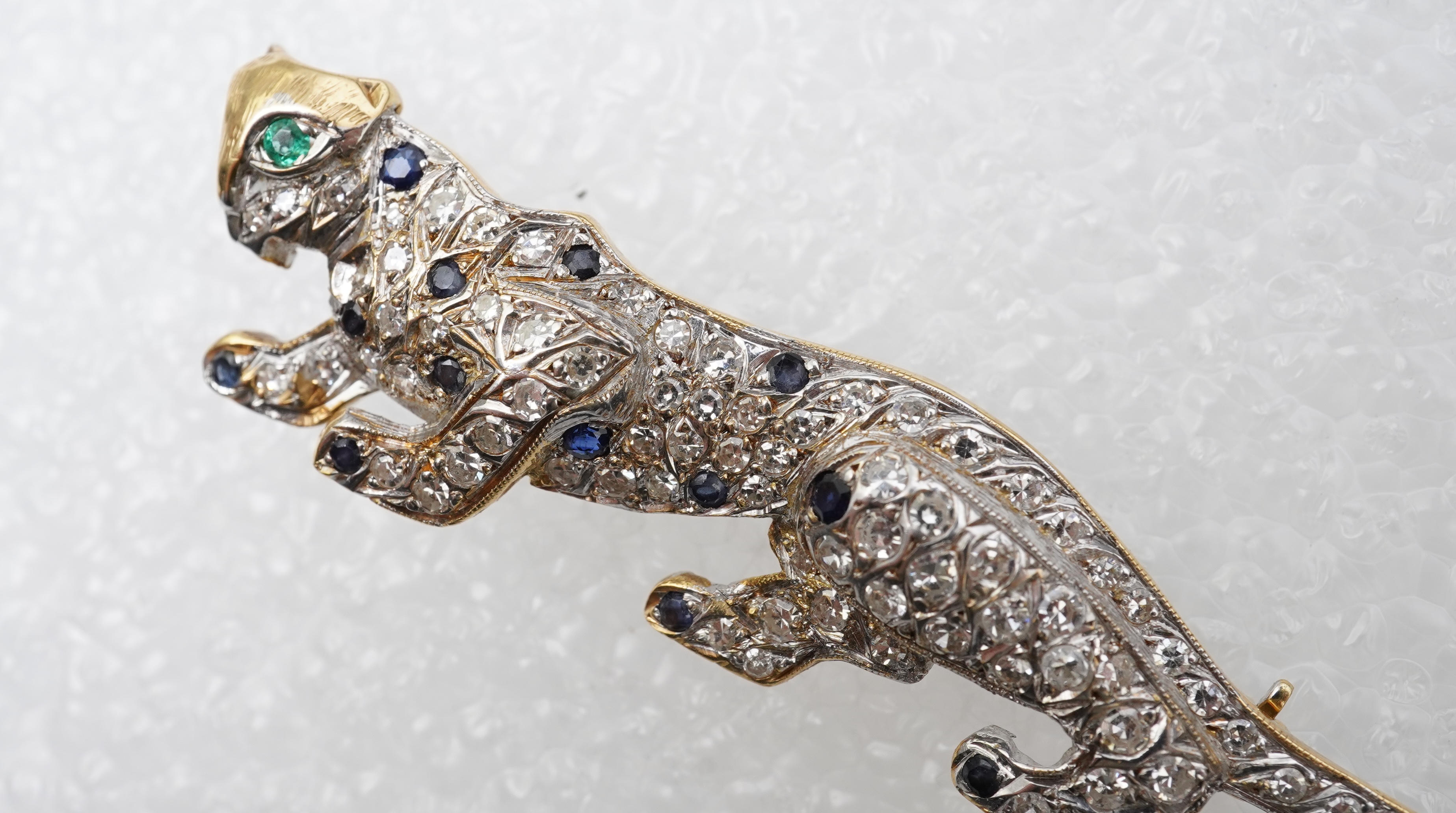 A sapphire, emerald and diamond brooch, circa 1988